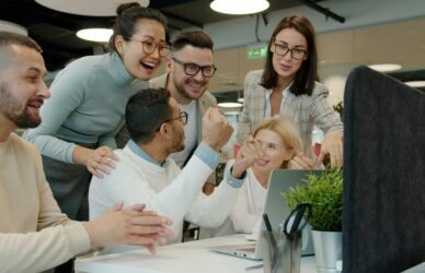 Colleagues celebrating a team achievement at work
